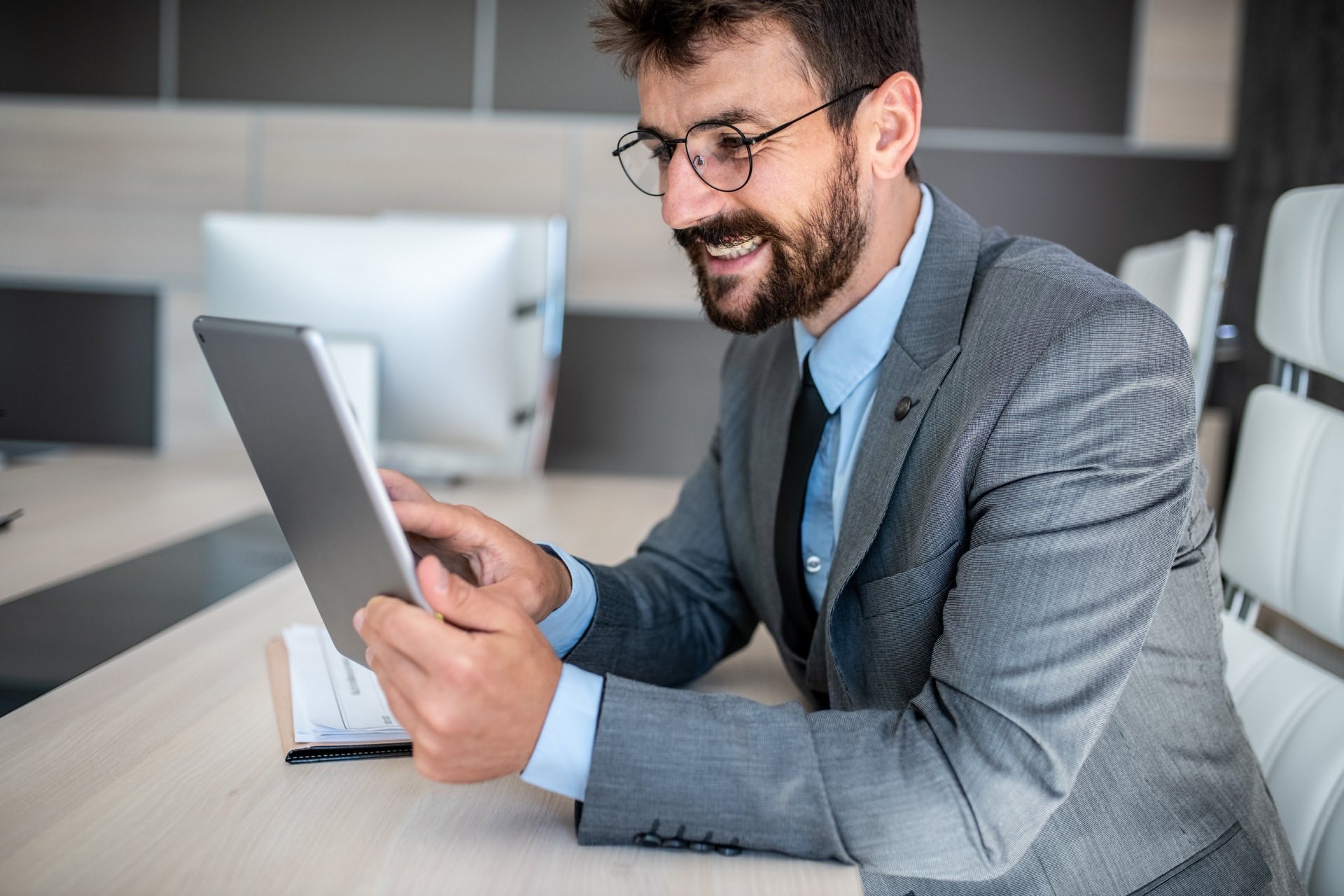 Entrepreneur enjoying reviewing project details on a tablet.