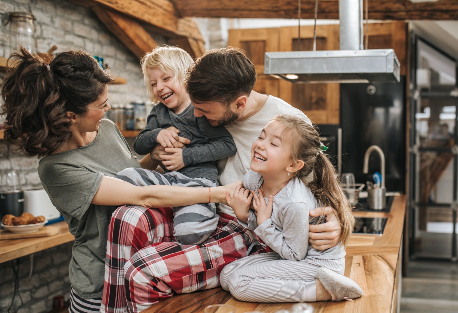 Playful family having fun during morning time in the kitchen.